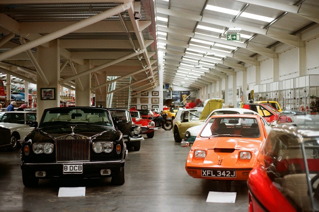 Interior of a classic car museum with restored vintage automobiles on display