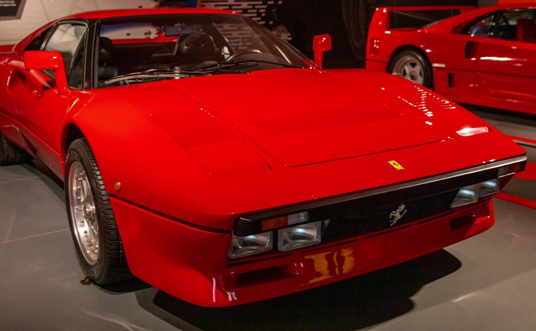 Vintage red Ferrari displayed at a formal classic car auction event