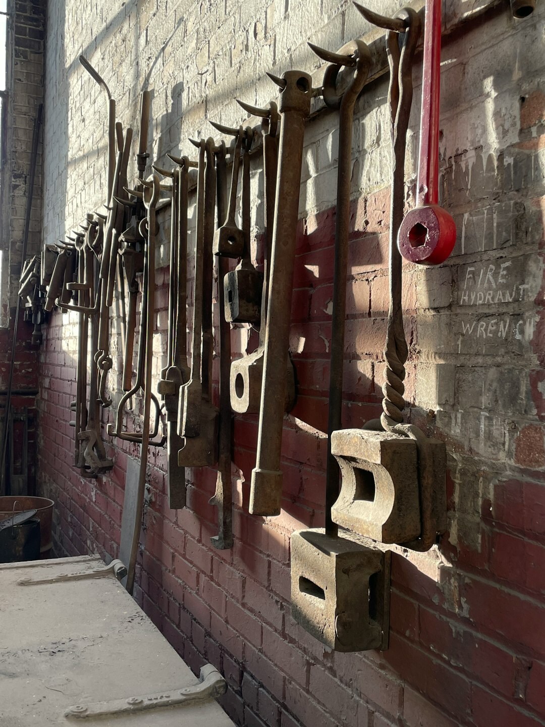 Historic brick garage filled with vintage automobiles and old tools