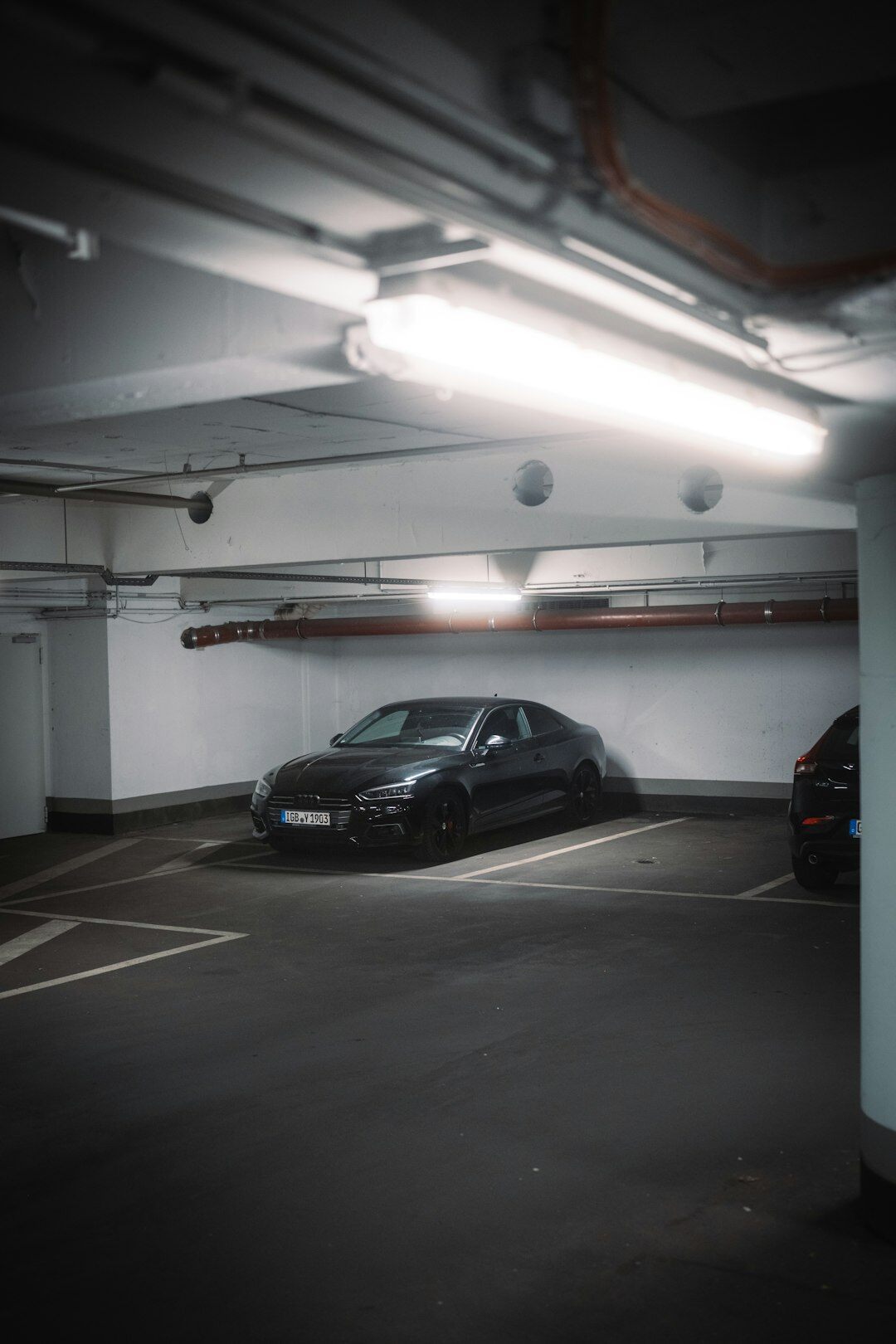 Dimly lit private garage filled with rare collectible automobiles