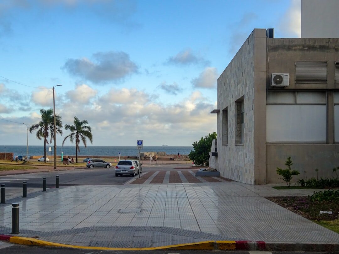 Coastal avenue of Montevideo with a classic car parked by the seaside promenade